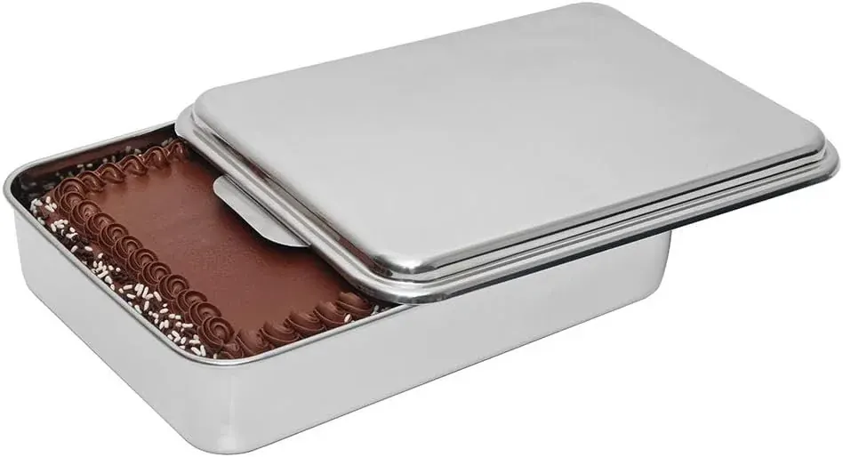 Rectangular stainless steel cake pan with sliding lid over frosted cake
