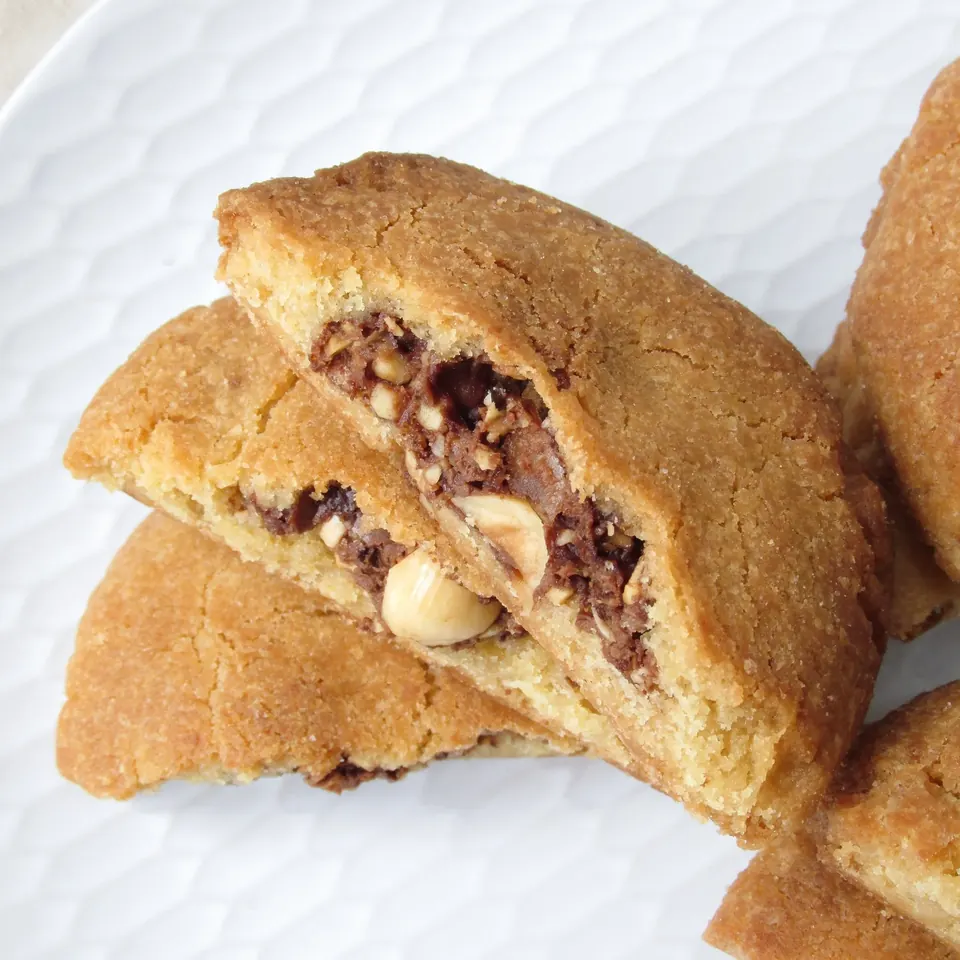 Stacked Ferrero Rocher cookies with visible hazelnut and chocolate filling