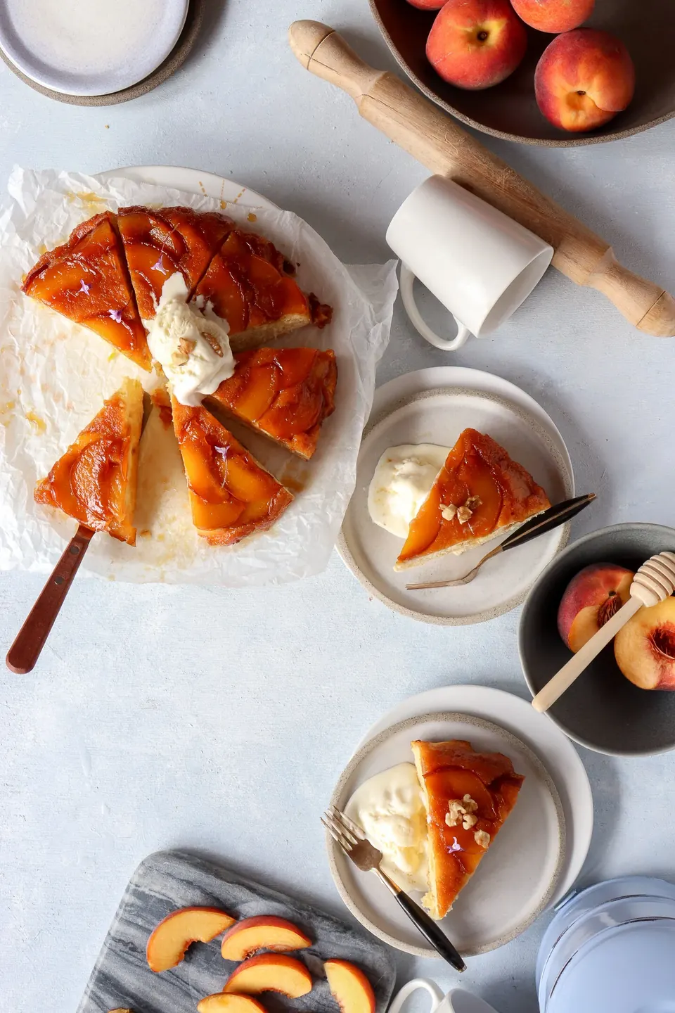 Overhead view of peach tarte tatin cake slices with whipped cream