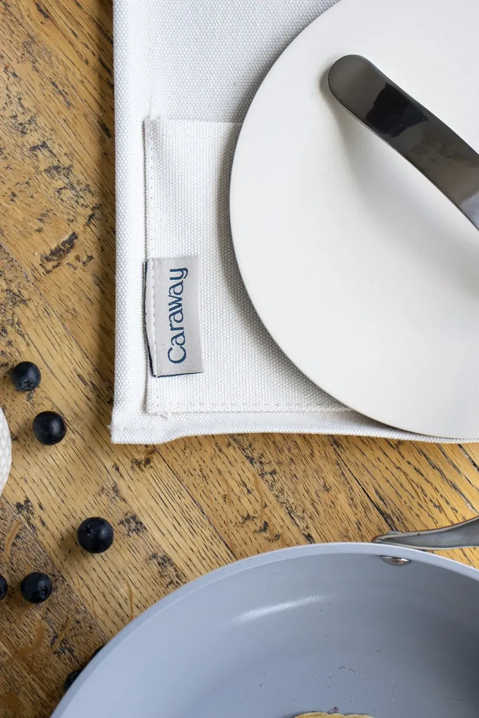 Caraway skillet beside plate and napkin on wooden table