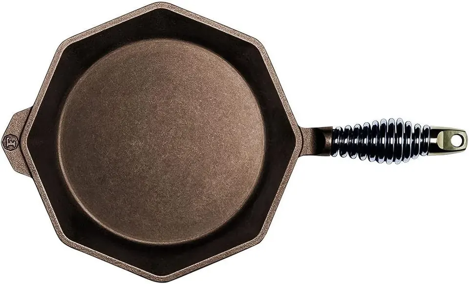 Octagonal cast iron skillet with coiled metal handle on white