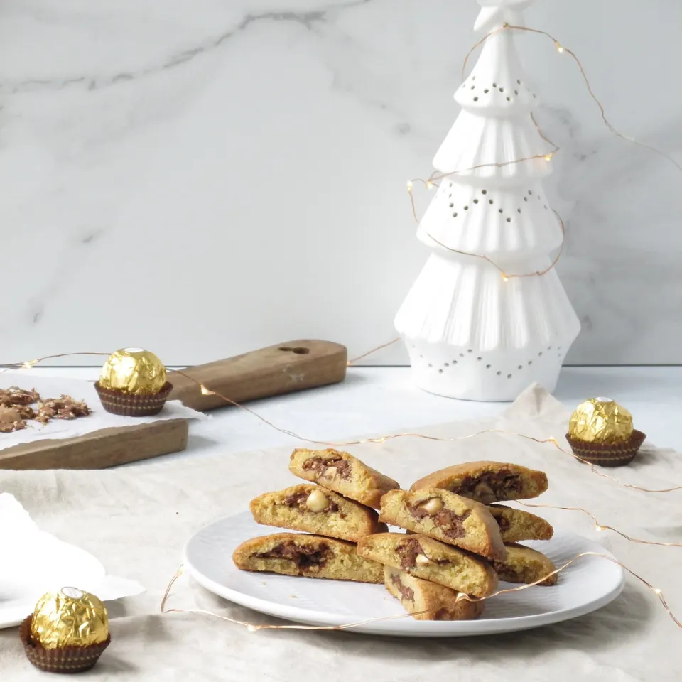 Ferrero Rocher stuffed cookies on plate with festive gold candies