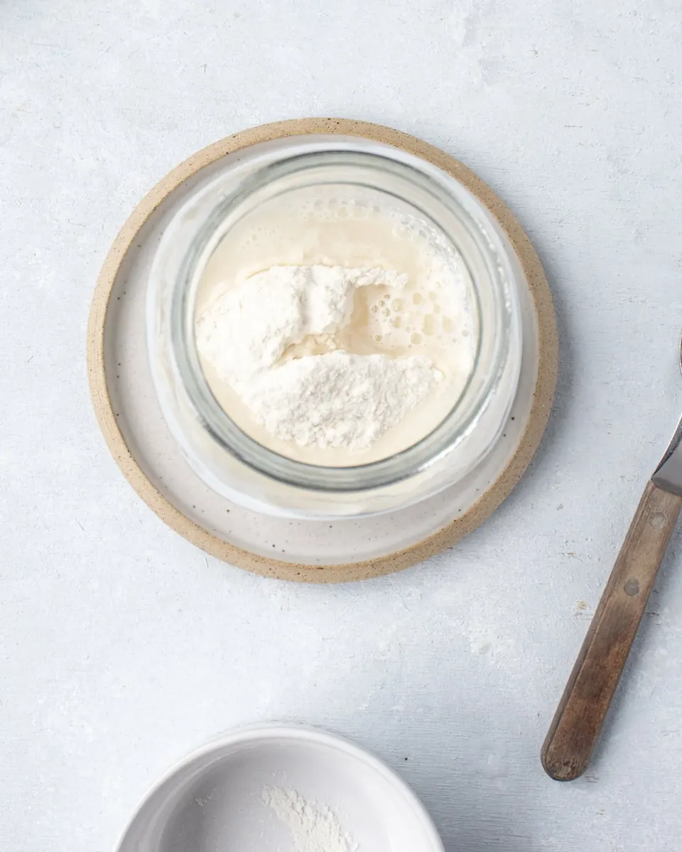 Flour and water in glass jar for sourdough starter