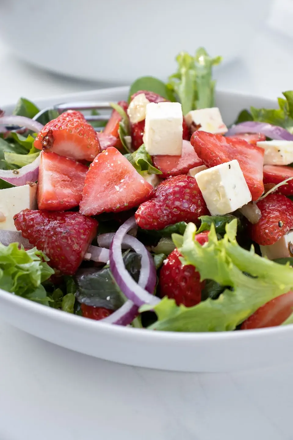 Strawberry feta salad with mixed greens and red onion