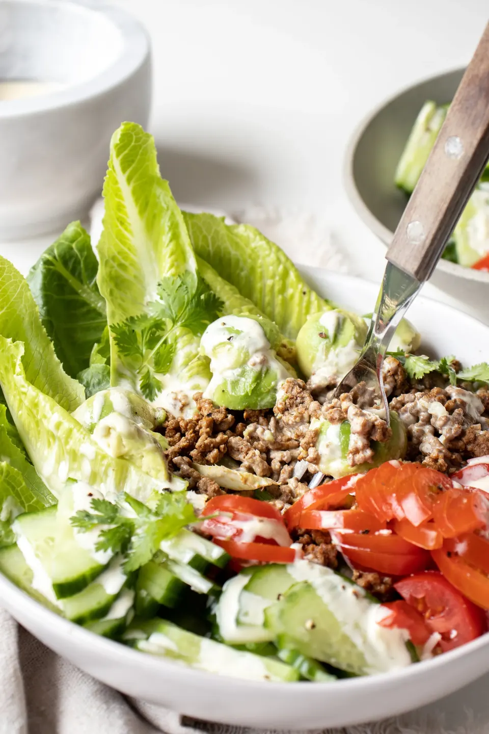 Burger chopped salad with romaine, ground beef, avocado, cucumber, and tomato