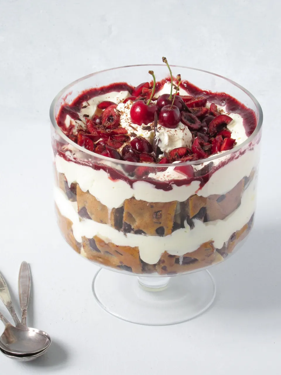 Cherry cake trifle layered with cream in a glass bowl